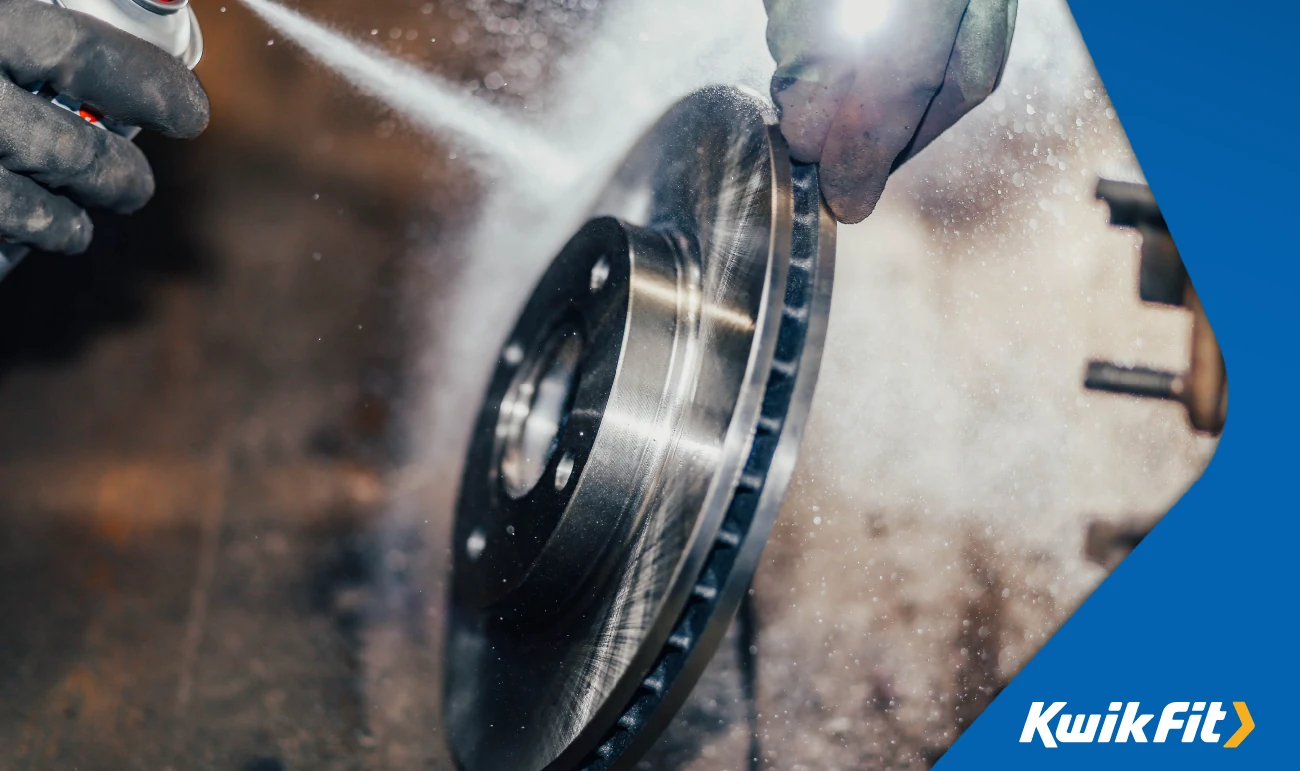 Spray cleaning a brake disc